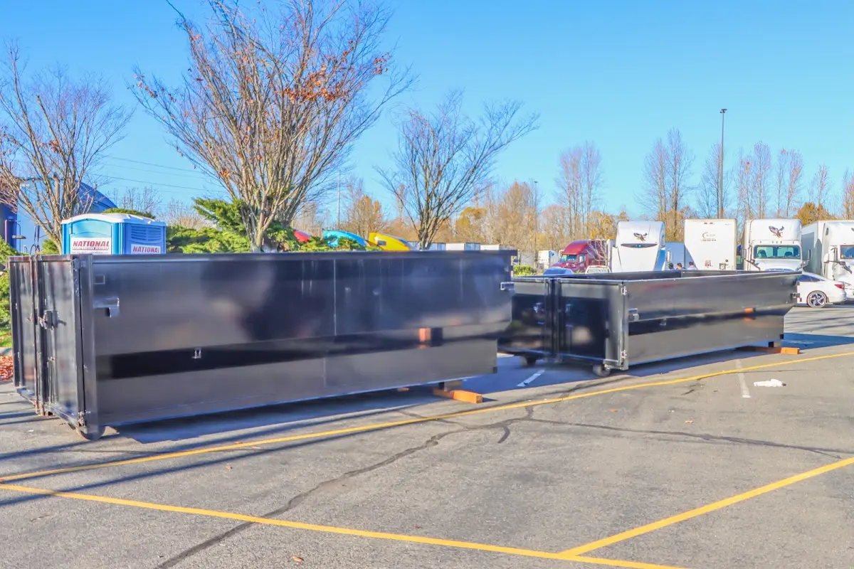 Professional dumpster rental service with roll-off container on residential driveway in Zimmerman